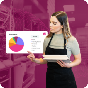 Woman in apron reviewing inventory in restaurant kitchen