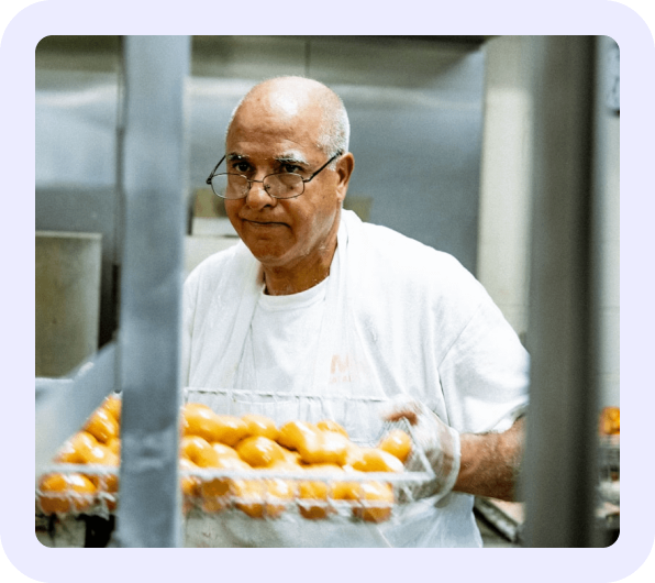 Chef holding tray of potatoes