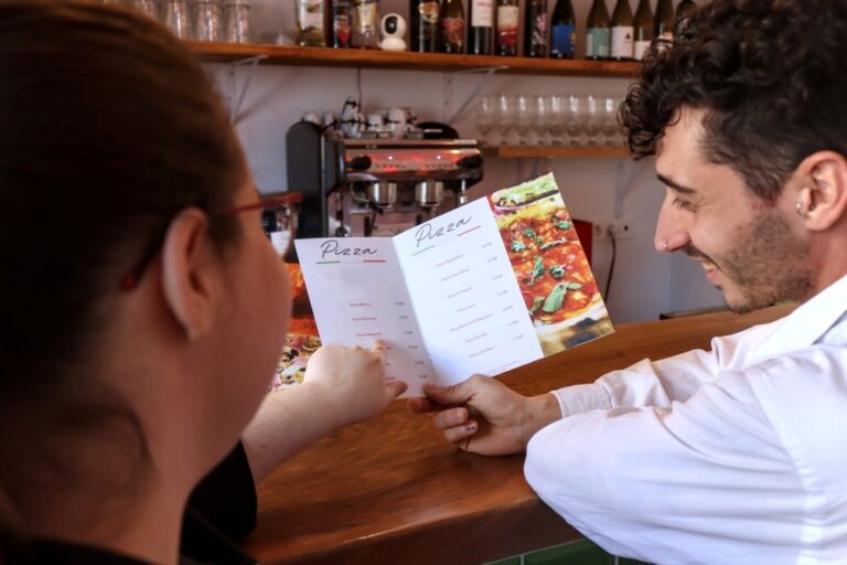 Wait staff advises customer on menu.