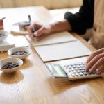 Clerk calculates the cost of a serving of coffee.