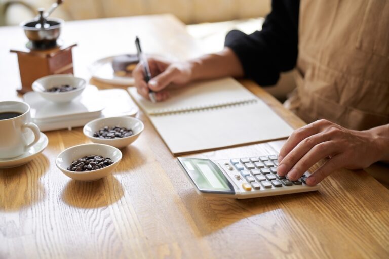 Clerk calculates the cost of a serving of coffee.