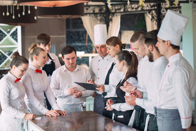 A group of restaurant staff optimizes restaurant operations as a team effort.