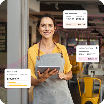 Woman working in restaurant smiling with iPad
