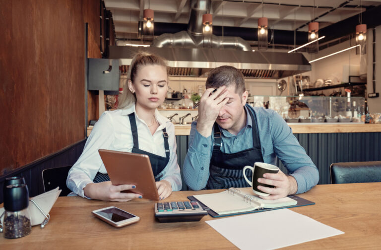 Nervous manager checking restaurant finances