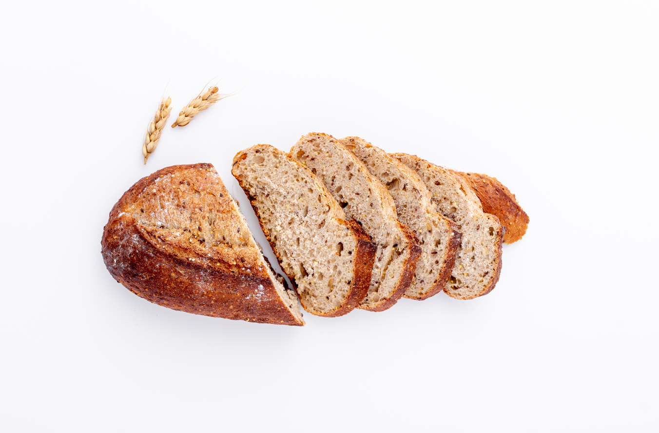 grains commodity update from back office - cut slices of wheat bread on white background
