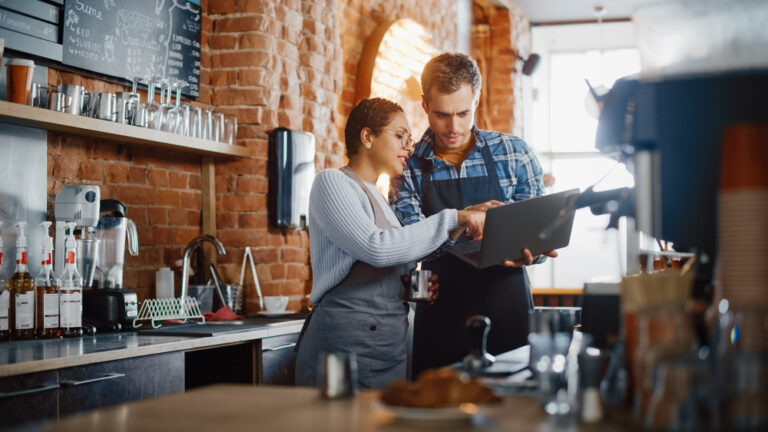 Two restaurant owners discussing menu pricing.
