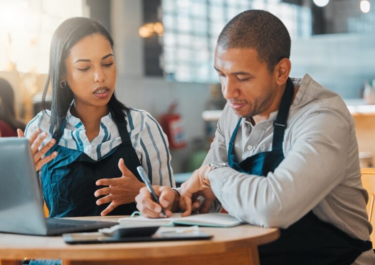 Restaurant owners discussing cash flow vs. profit.