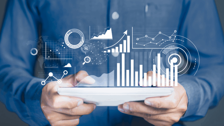 Hands holding tablet with floating graphs