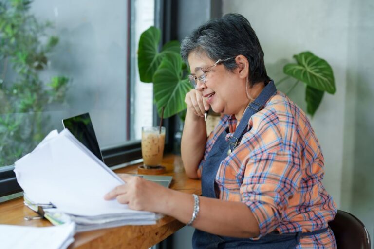 Restaurant operator reviewing invoices and reports while conducting a restaurant audit