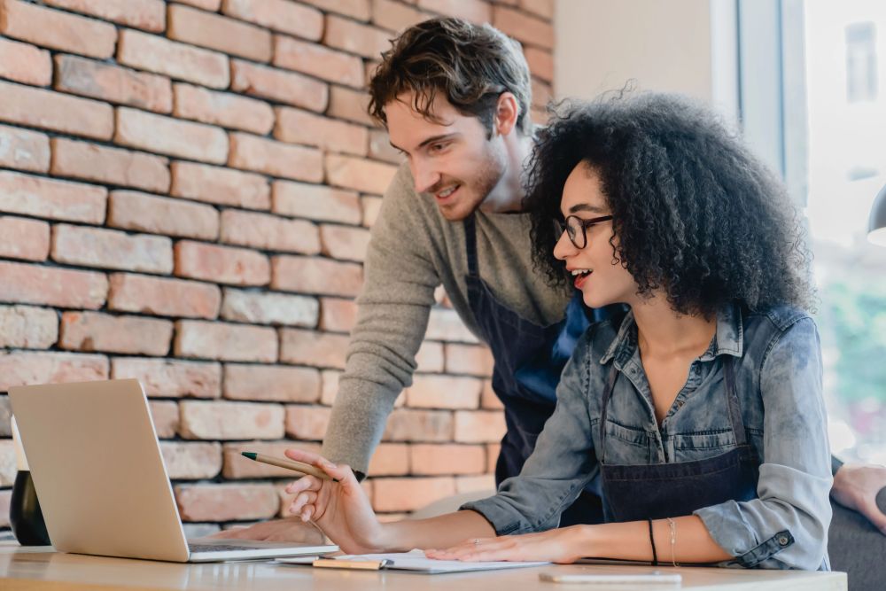 Two restaurant operators reviewing financial data to manage costs and improve profitability