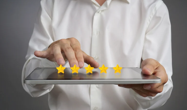 Hands tapping a five-star rating on a tablet.
