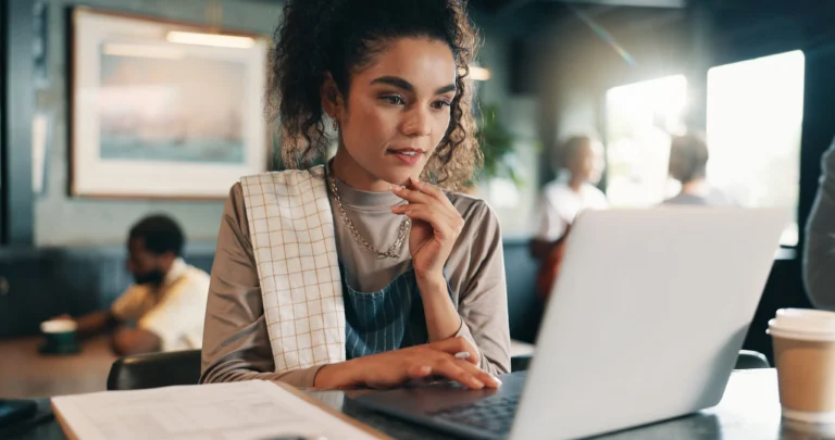 Restaurant professional analyzing financial data on a laptop in a café setting
