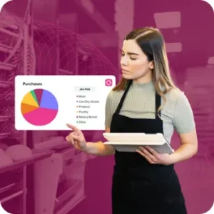 Woman in apron reviewing inventory in restaurant kitchen