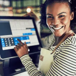 Woman smiling in front of Restaurant Point Of Sale System