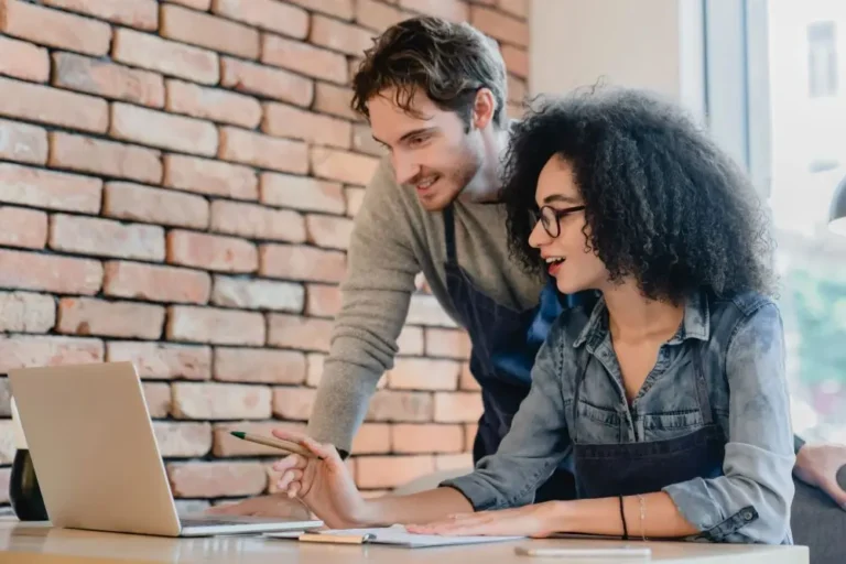 Two restaurant operators reviewing financial data to manage costs and improve profitability