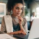 Restaurant professional analyzing financial data on a laptop in a café setting
