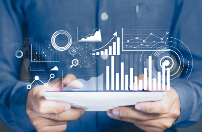 Hands holding tablet with floating graphs