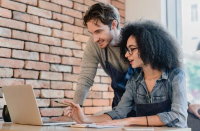 Two restaurant operators reviewing financial data to manage costs and improve profitability