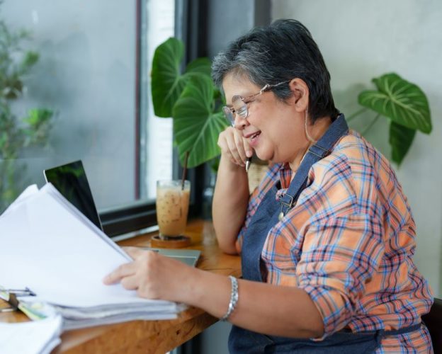 Restaurant operator reviewing invoices and reports while conducting a restaurant audit