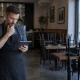 A restaurant manager reviewing closing information on a tablet