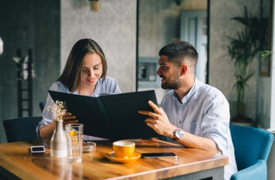 A happy young couple looking at a menu at a restaurant