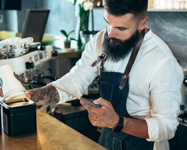 Barista doing an inventory of the products in a cafe