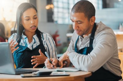 Restaurant owners discussing cash flow vs. profit.